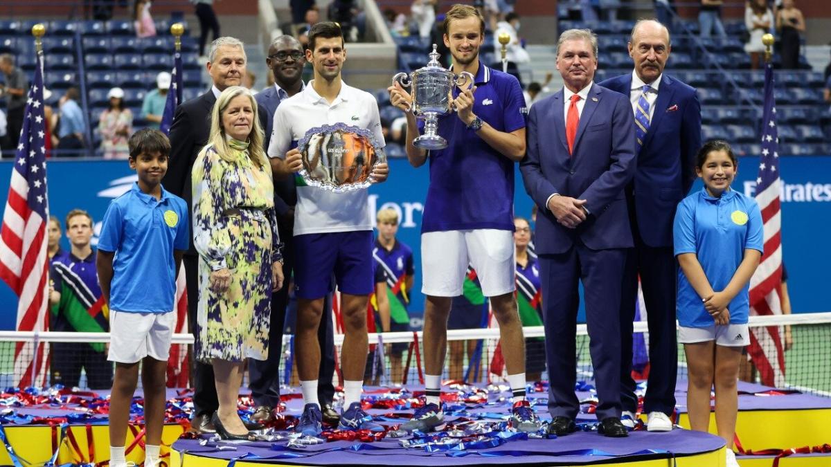 Defending champion Daniil Medvedev holds aloft the trophy in 2021